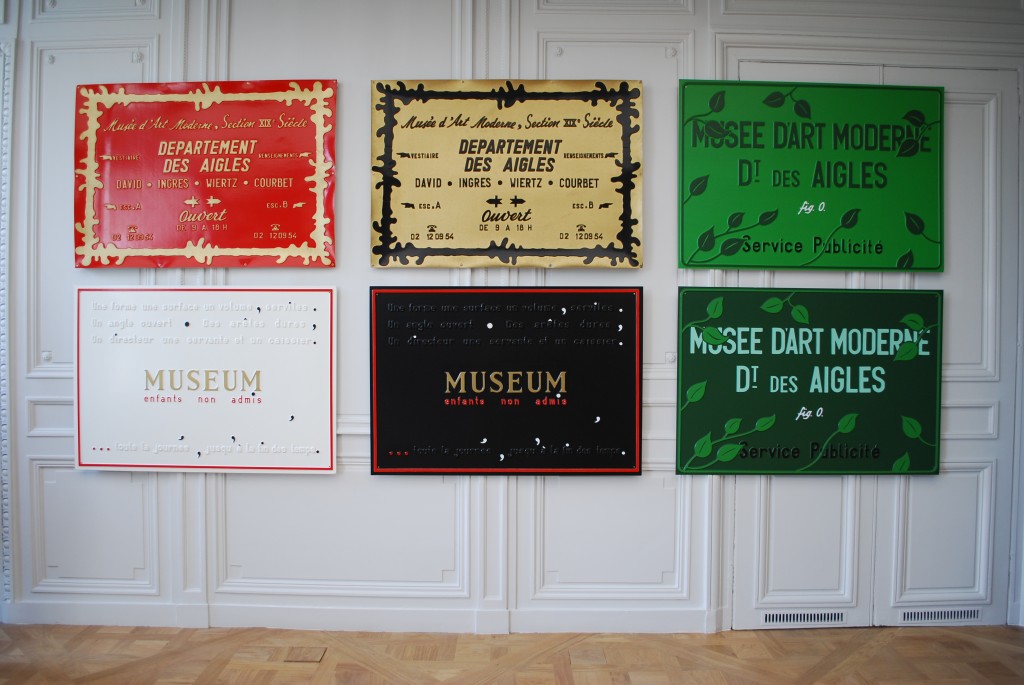 Plaques (Poèmes industriels) (1968-1972), 16 plaques en plastique embouti et peint,  Estate Marcel Broodthaers, prêt de longue durée S.MA.K. Gand. Salle 6.